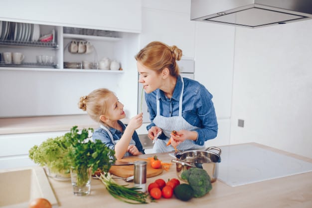 mother and daughter preparing fresh vegetables together