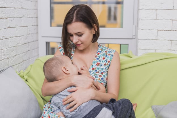 happy woman breastfeeding her baby