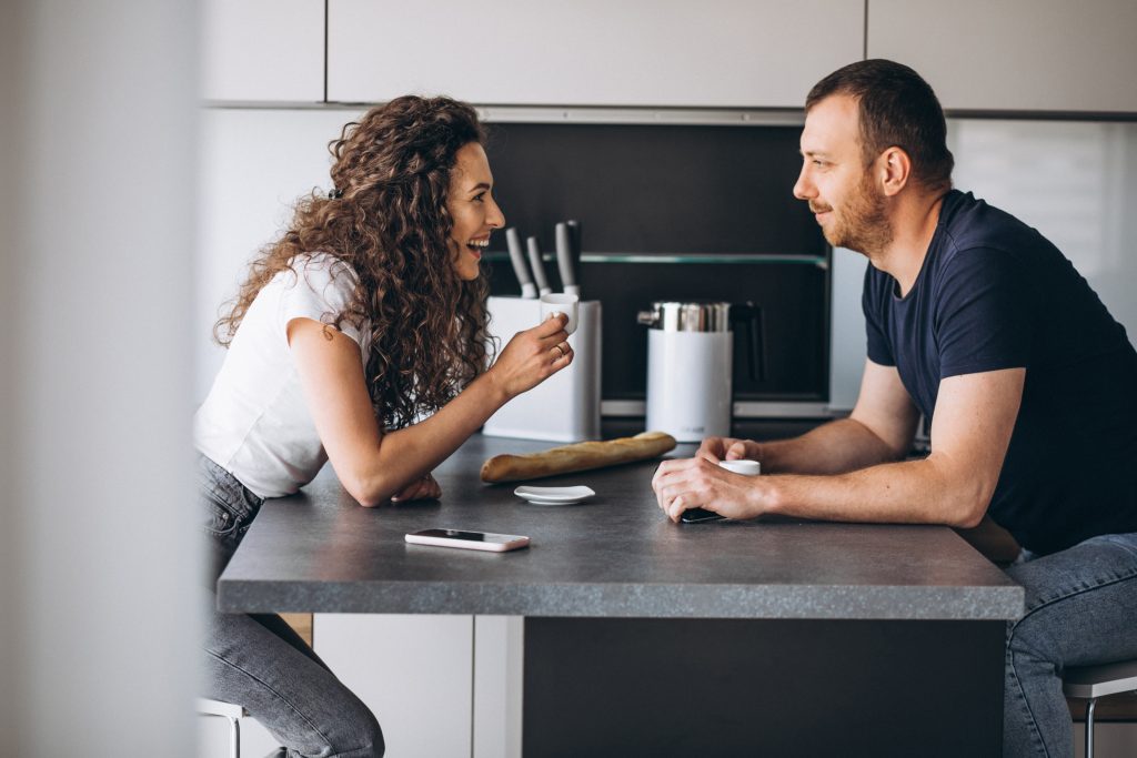 Couple together at the kitchen drinking coffee