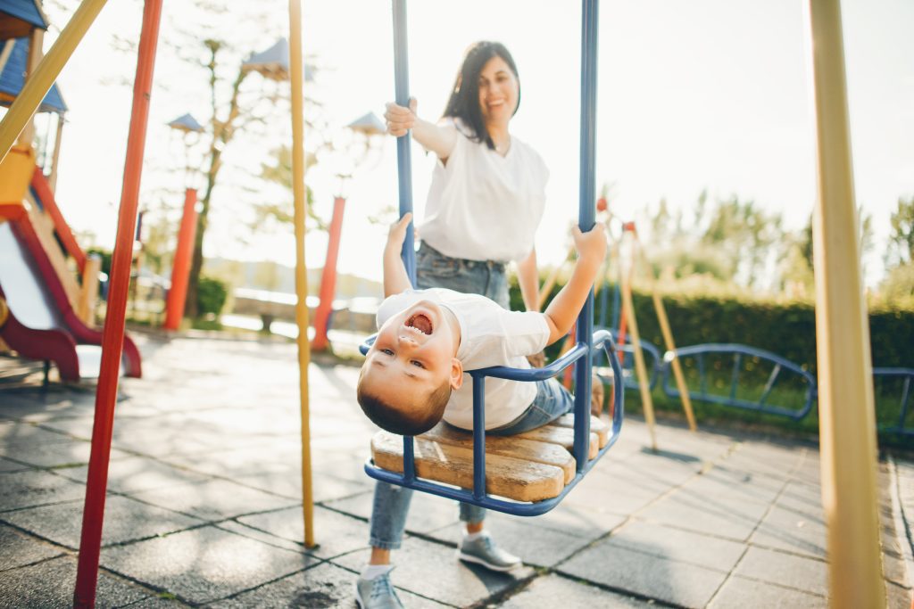 Family in a park. Mother with son. People on a playground.